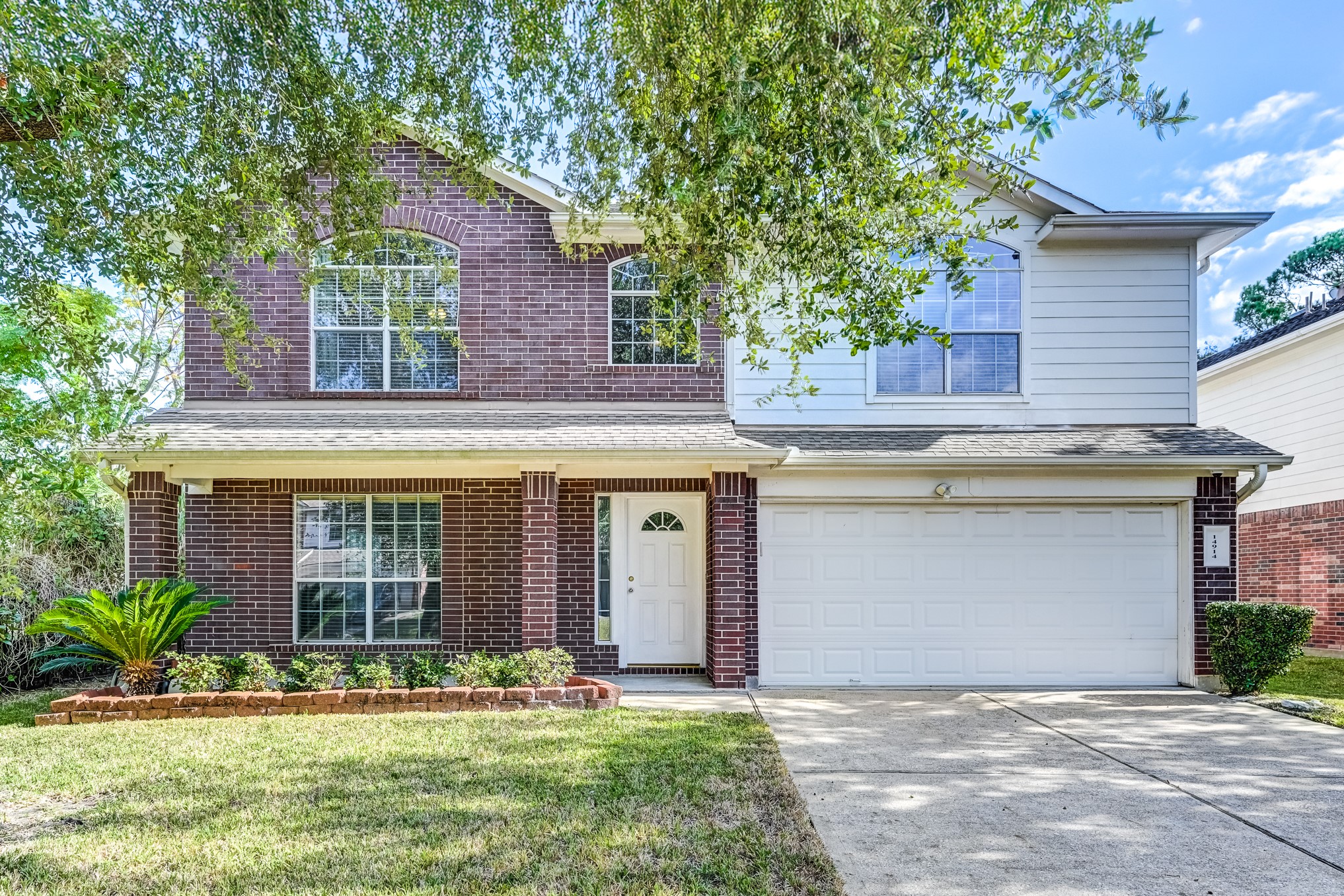 14914 Forest Enclave Lane Houston, TX 77068 - Photo 1 of 49 a front view of a house with garden