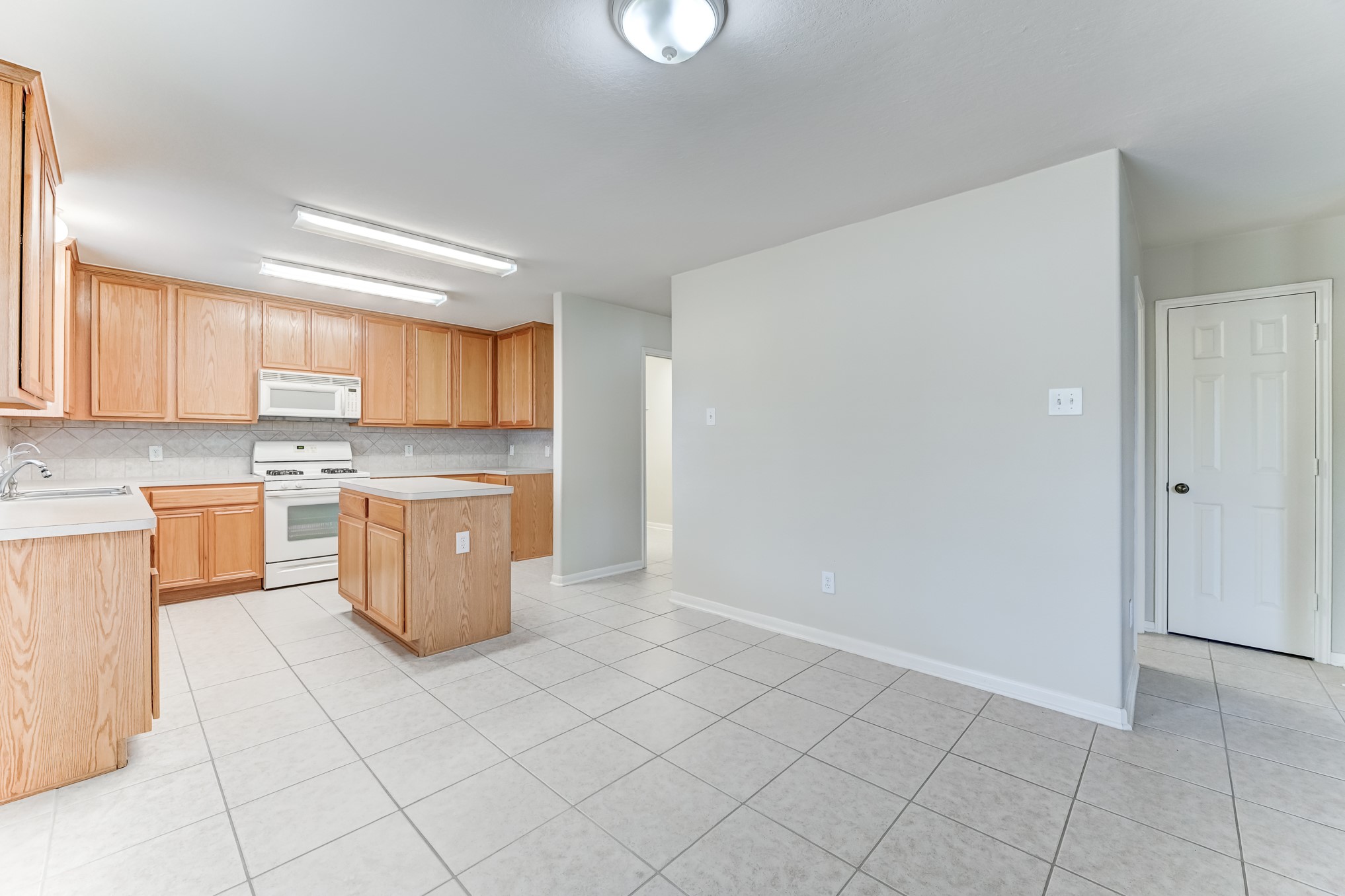 14914 Forest Enclave Lane Houston, TX 77068 - Photo 14 of 49 a kitchen with a white cabinets