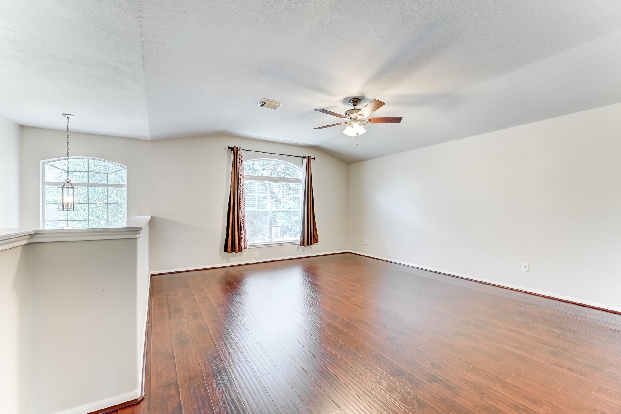 14914 Forest Enclave Lane Houston, TX 77068 - Photo 22 of 49 an empty room with wooden floor and windows