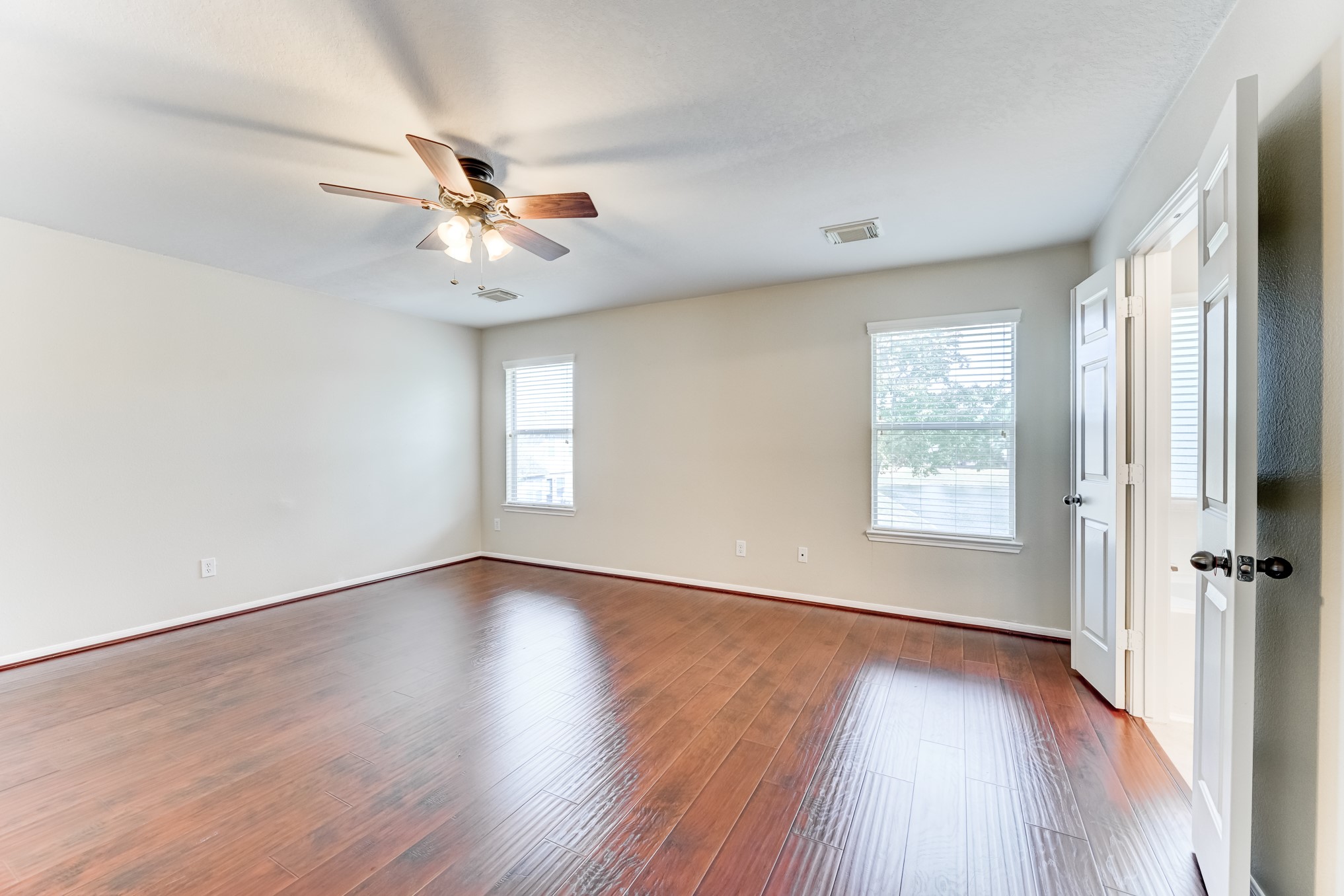 14914 Forest Enclave Lane Houston, TX 77068 - Photo 24 of 49 an empty room with wooden floor fan and windows