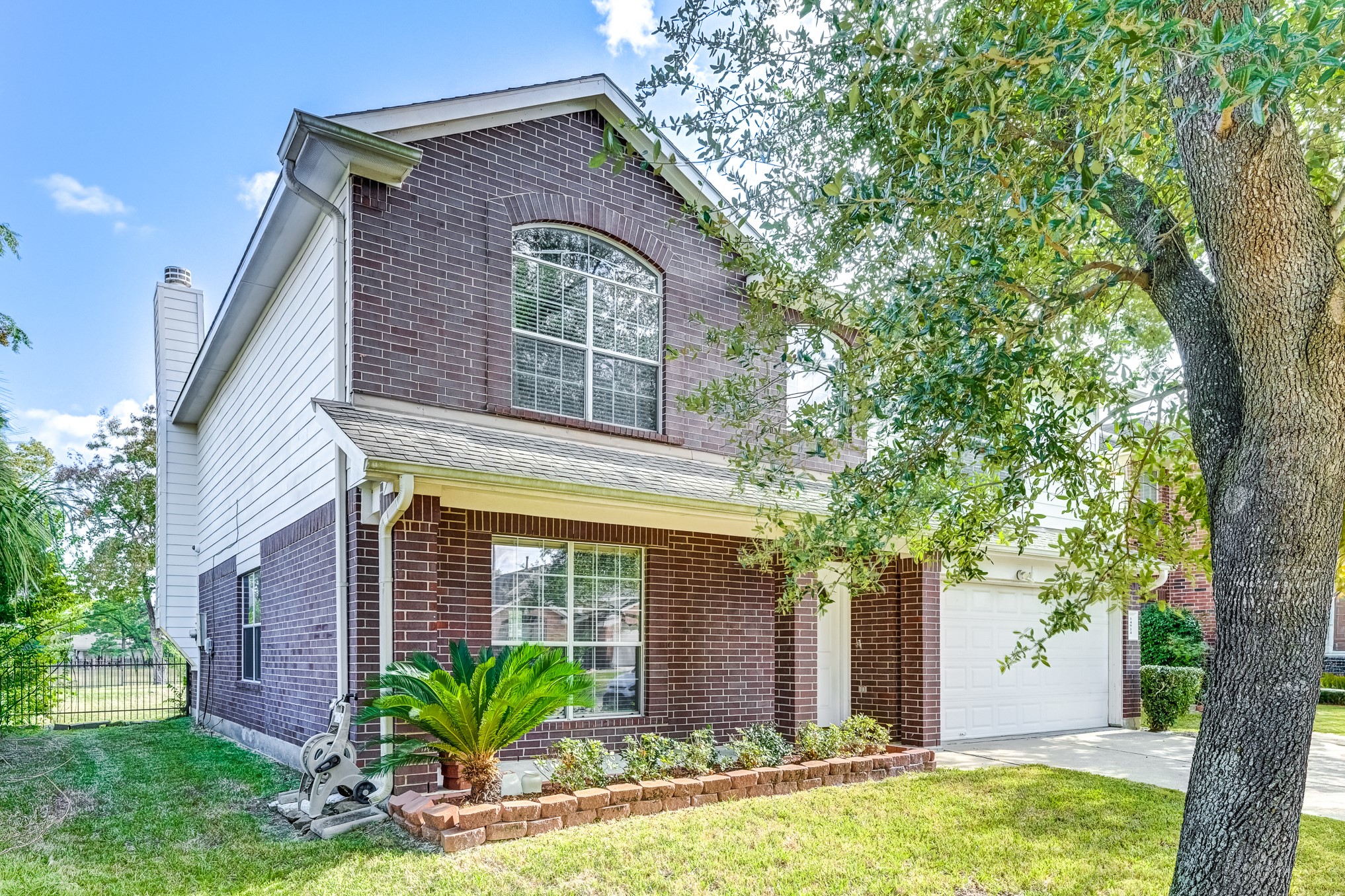 14914 Forest Enclave Lane Houston, TX 77068 - Photo 3 of 49 a front view of a house with garden