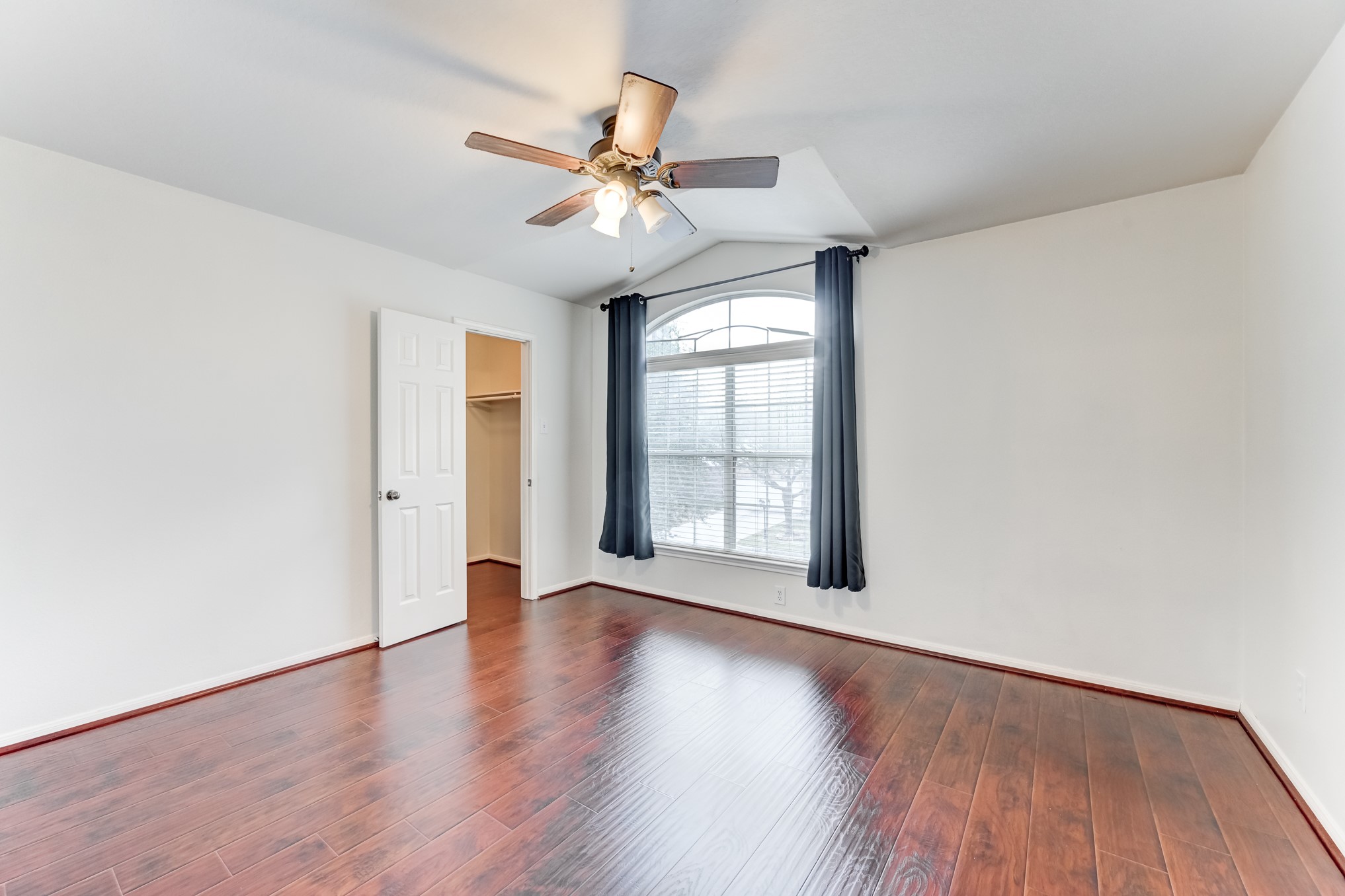 14914 Forest Enclave Lane Houston, TX 77068 - Photo 35 of 49 a view of an empty room with wooden floor and a window