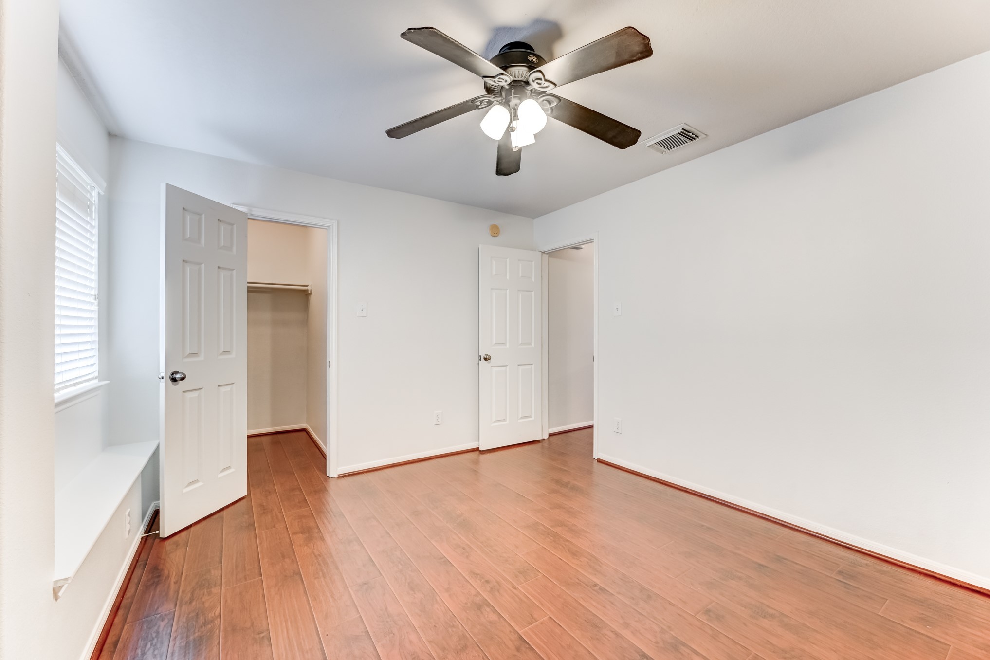 14914 Forest Enclave Lane Houston, TX 77068 - Photo 40 of 49 a view of an empty room with window and wooden floor