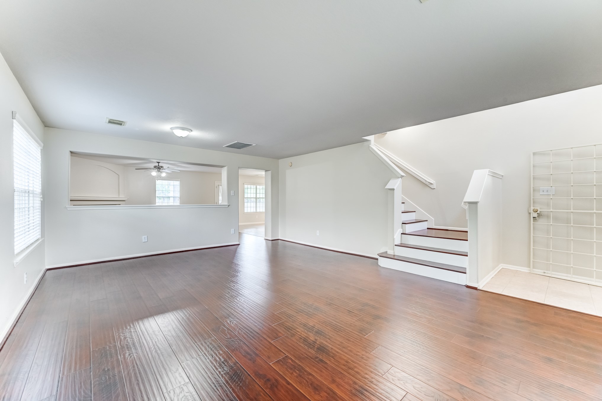 14914 Forest Enclave Lane Houston, TX 77068 - Photo 7 of 49 a view of an empty room with wooden floor and a window