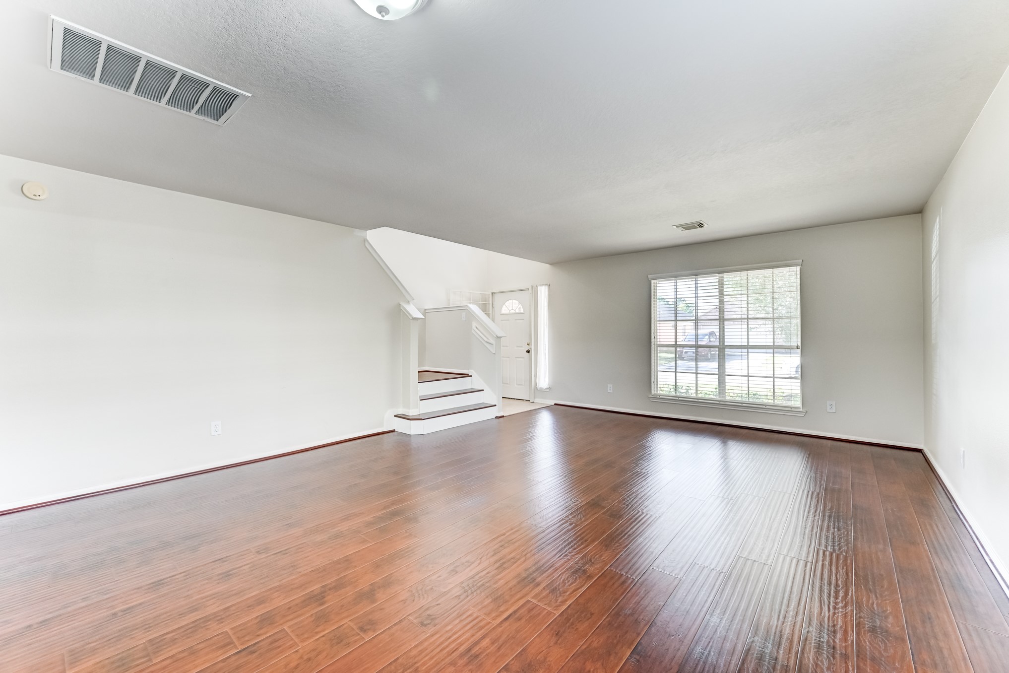 14914 Forest Enclave Lane Houston, TX 77068 - Photo 9 of 49 a view of an empty room with wooden floor and window