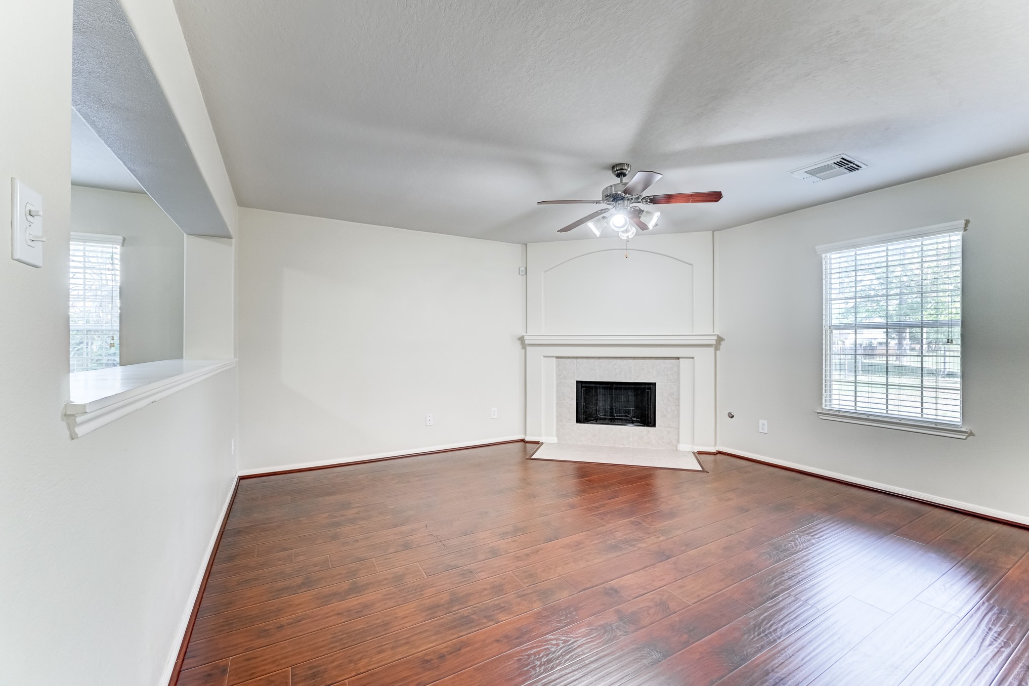 14914 Forest Enclave Lane Houston, TX 77068 - Photo 10 of 49 a view of an empty room with a fireplace and a window