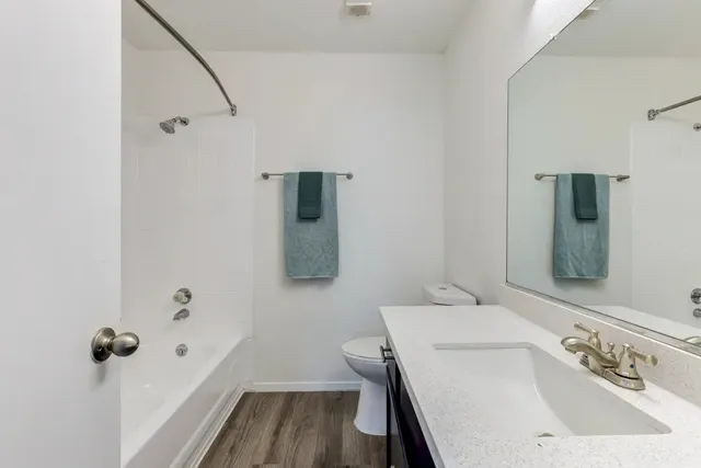 a bathroom with a sink toilet and shower