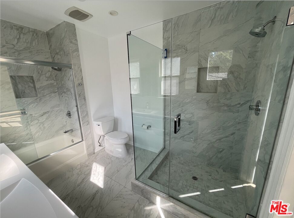 437 Shirley Place, Unit D Beverly Hills, CA 90212 - Photo 12 of 16 a bathroom with a glass shower door and a sink