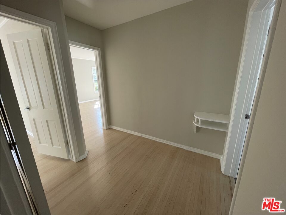 437 Shirley Place, Unit D Beverly Hills, CA 90212 - Photo 9 of 16 an empty room with wooden floor