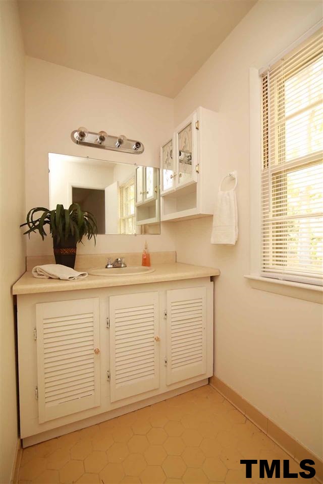 411 East Rowan Street Raleigh, NC 27609 - Photo 18 of 25 a bathroom with a sink and a mirror