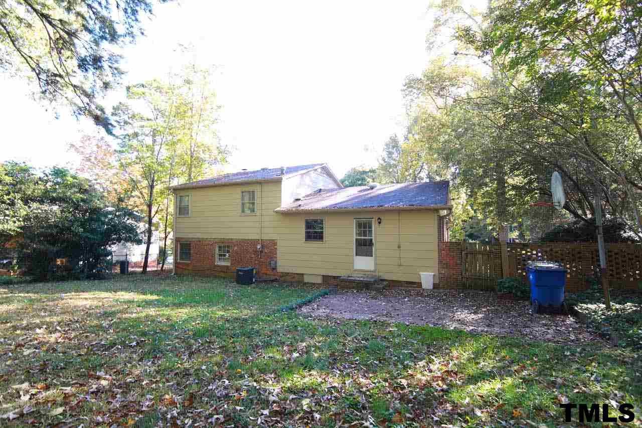 411 East Rowan Street Raleigh, NC 27609 - Photo 21 of 25 a view of a house with backyard and a tree