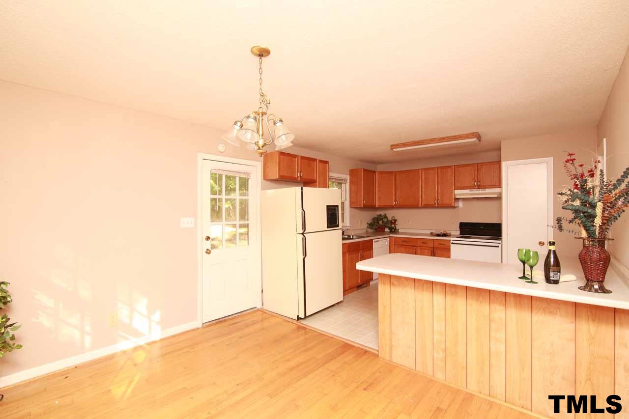 411 East Rowan Street Raleigh, NC 27609 - Photo 10 of 25 a view of a kitchen with kitchen island and stainless steel appliances
