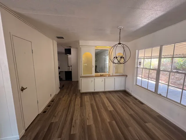 a bathroom with a sink mirror toilet and window
