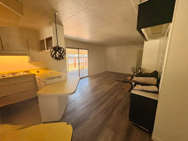 a kitchen with a sink a refrigerator and a stove top oven
