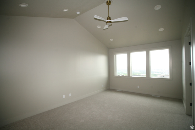 635 East Mountain Road North Ogden, UT 84414 - Photo 30 of 33 Spacious room featuring vaulted ceilings, a brass-finished ceiling fan, recessed lighting, and a triple window assembly
