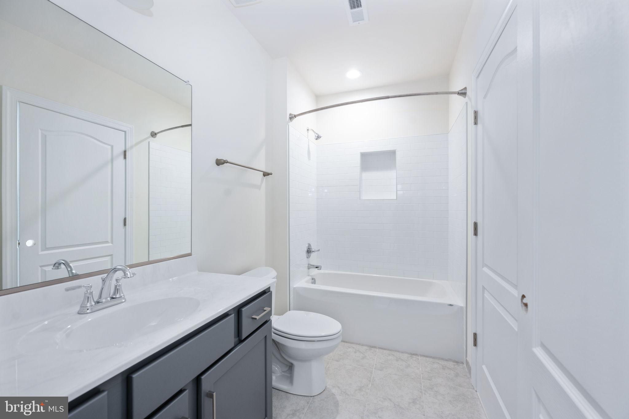 569 Tacketts Mill Road Stafford, VA 22556 - Photo 107 of 120 a bathroom with a granite countertop sink toilet a shower and a mirror