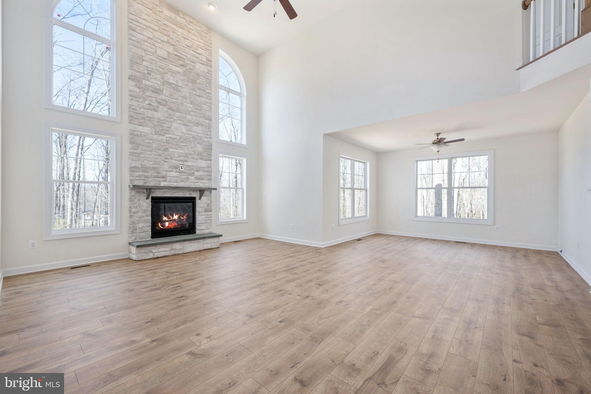 569 Tacketts Mill Road Stafford, VA 22556 - Photo 43 of 120 wooden floor fireplace and windows in an empty room