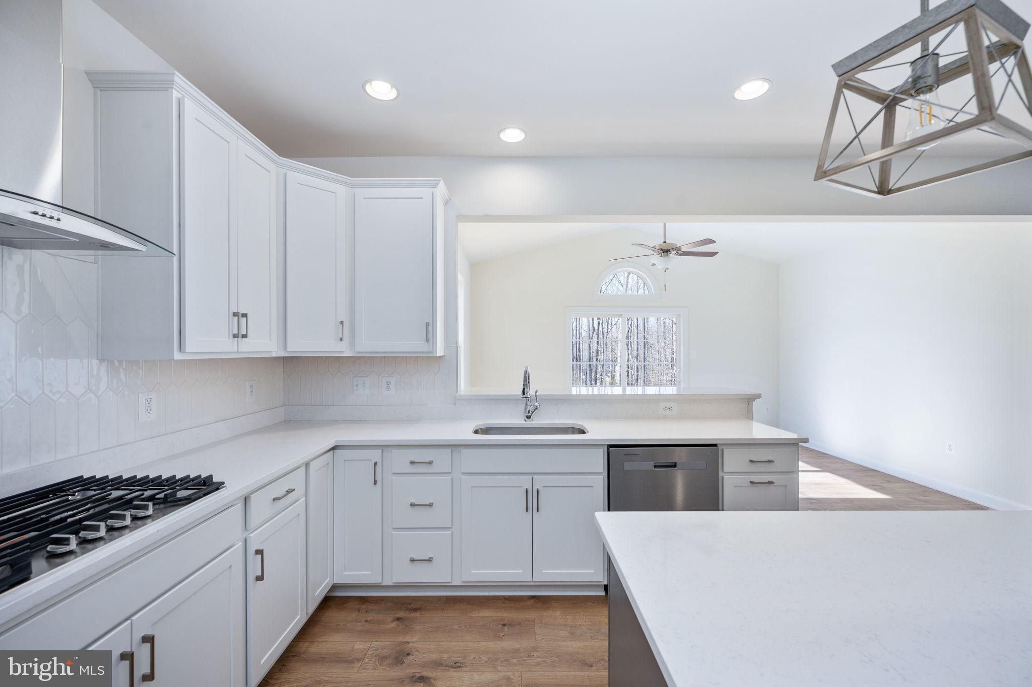 569 Tacketts Mill Road Stafford, VA 22556 - Photo 54 of 120 a kitchen with granite countertop a sink a stove and cabinets