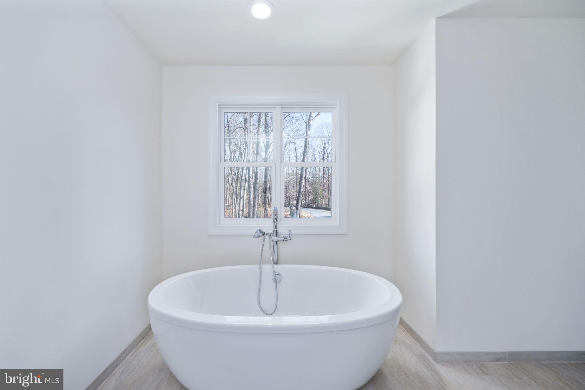 569 Tacketts Mill Road Stafford, VA 22556 - Photo 96 of 120 a white bath tub sitting in a bathroom