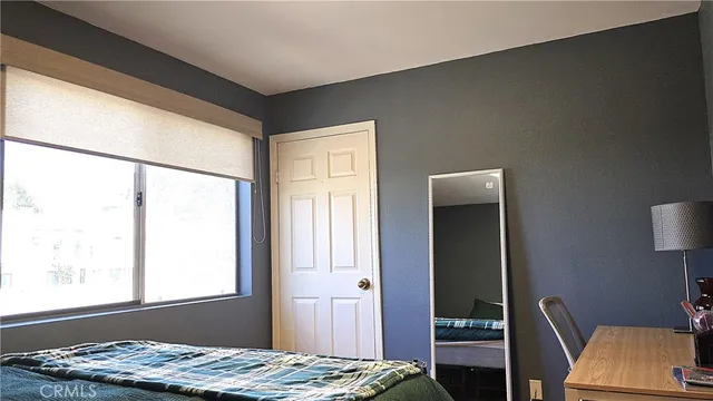a bedroom with furniture and a window