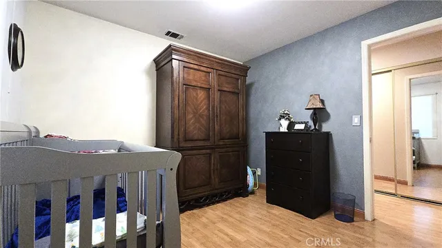 a view of closet with clothes and shoes