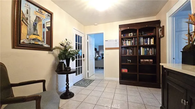 a living room with furniture a chandelier and a large window