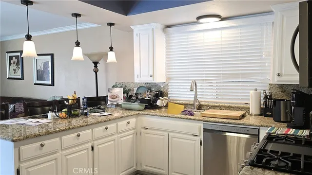 a kitchen with sink cabinets and appliances