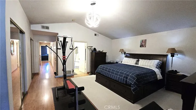 a bedroom with a bed and a mirror