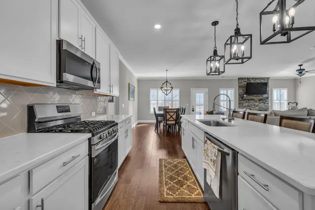 a kitchen with stainless steel appliances granite countertop a lot of counter space a sink and a stove