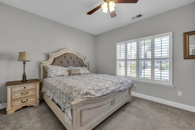 a spacious bedroom with a bed and a window