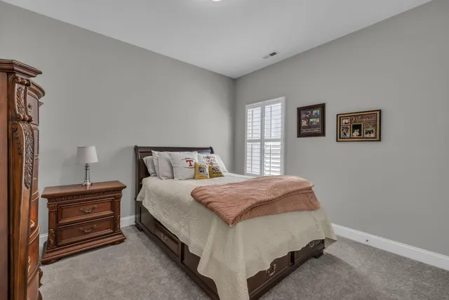 a spacious bedroom with a bed and a window