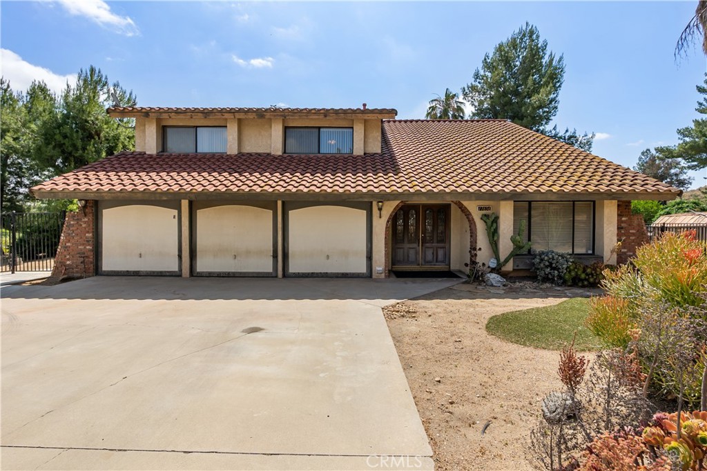 17656 Mockingbird Hill Circle Riverside, CA 92504 - Photo 3 of 49 a front view of a house with a garden