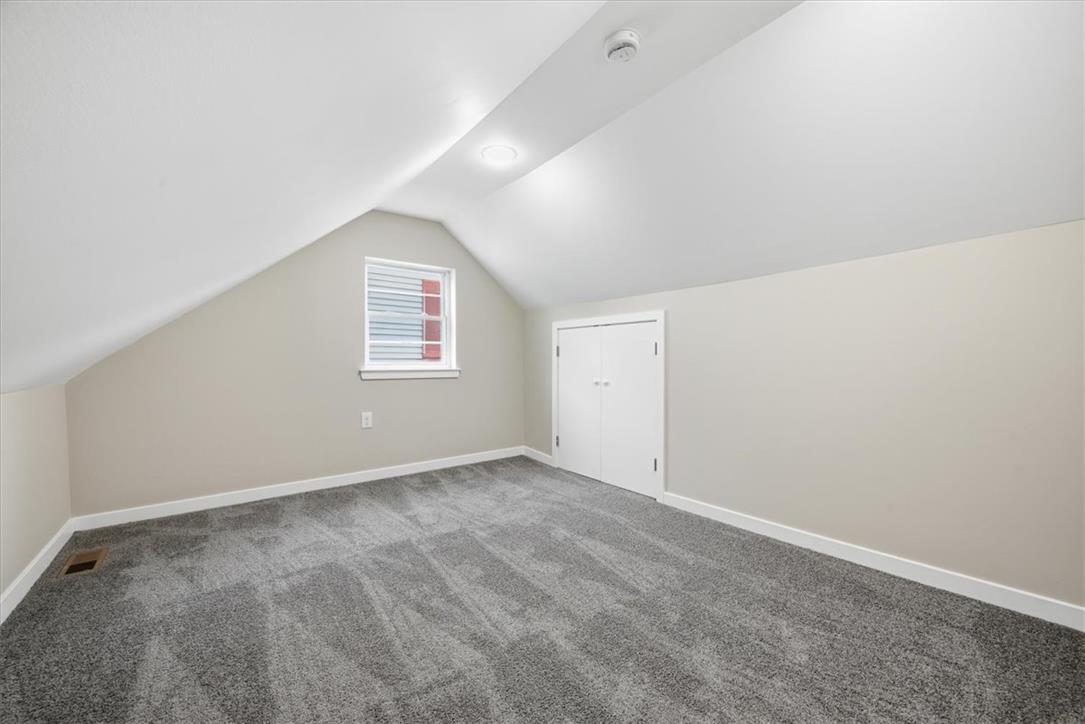 5641 North Coplay Road Whitehall, PA 18052 - Photo 43 of 68 Sloped ceilings and a single window define this inviting attic space, offering flexible possibilities.