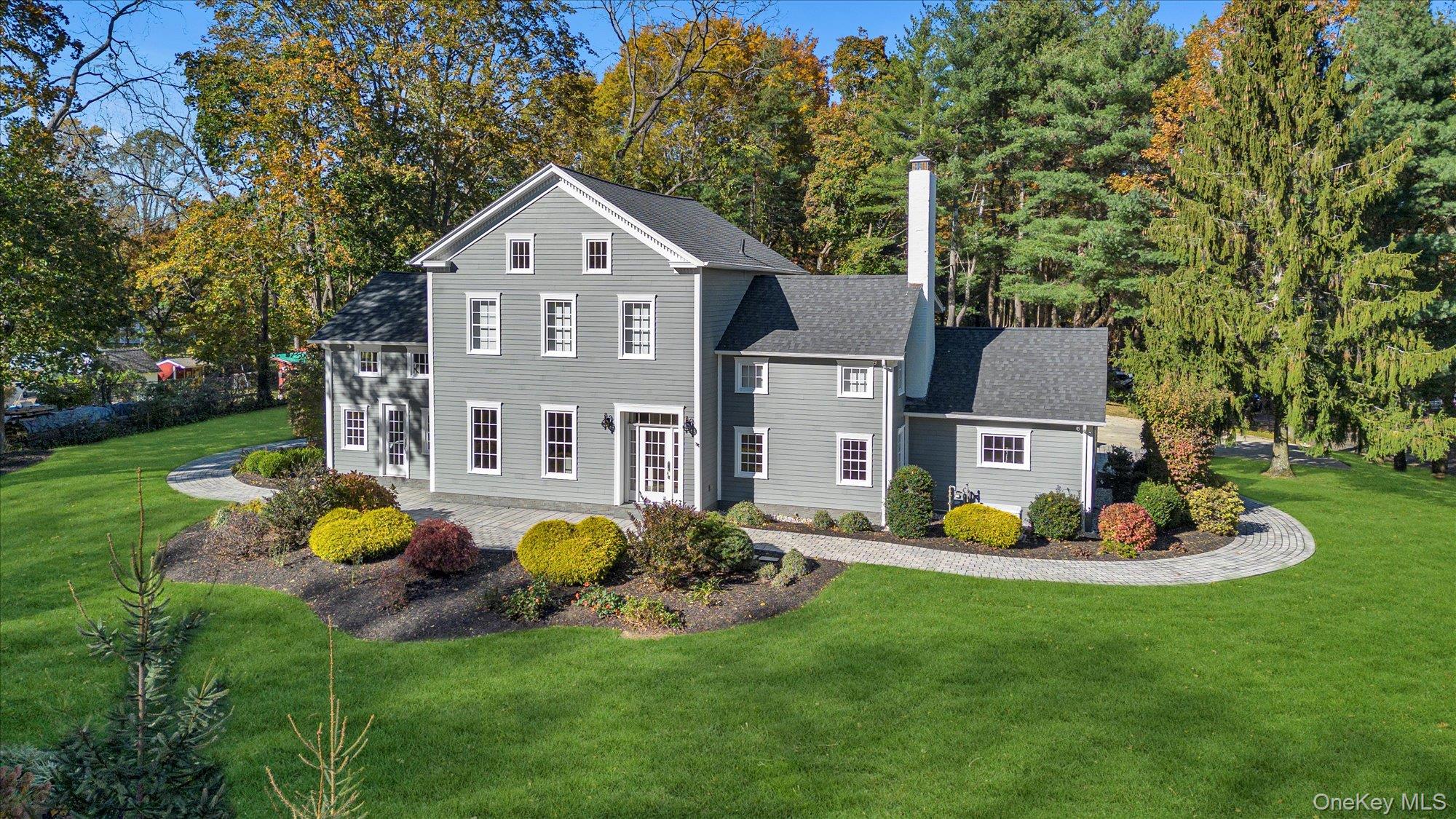 22 Fort Salonga Road Centerport, NY 11721 - Photo 1 of 1 View of front facade with a front yard