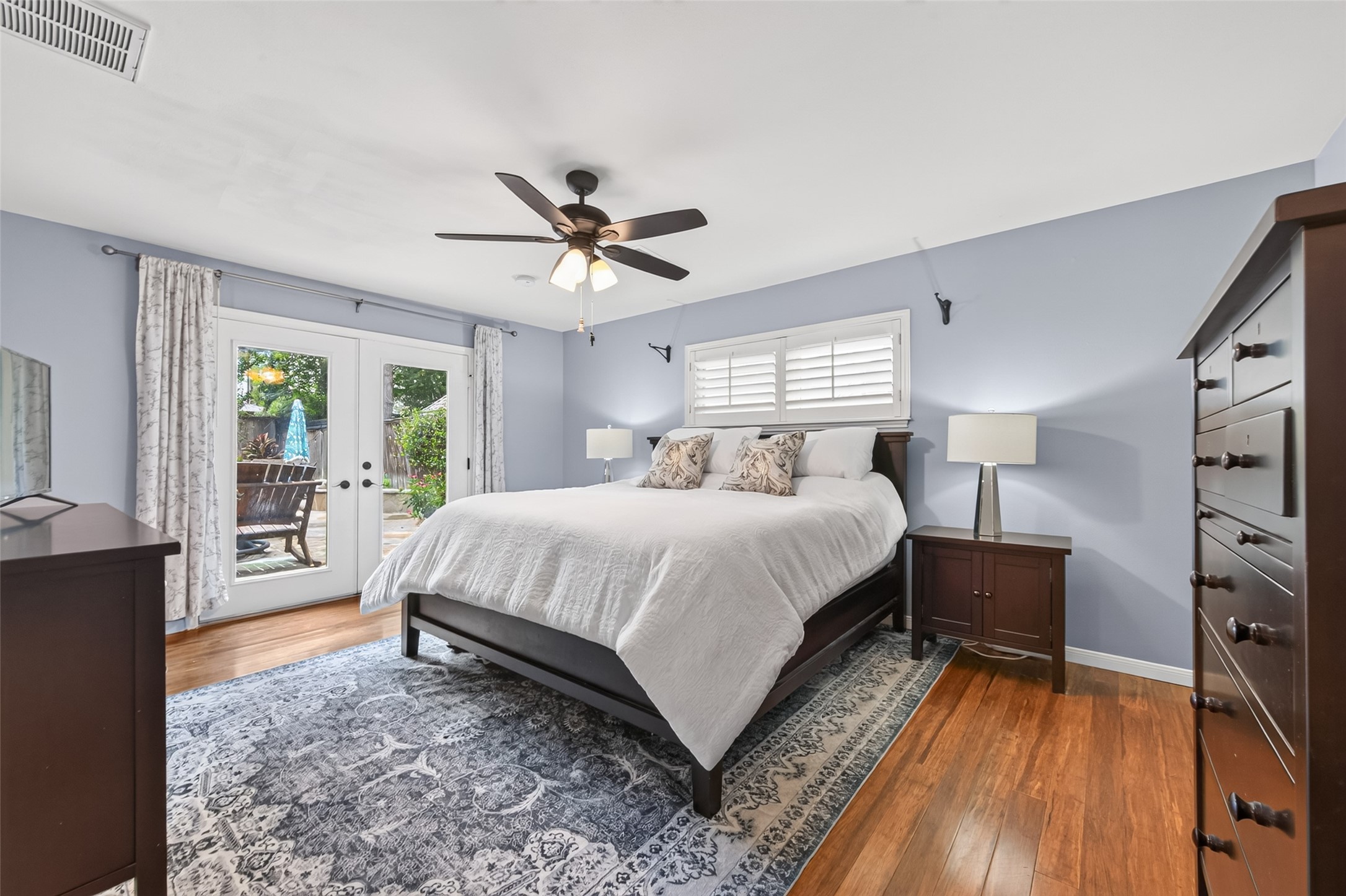 13506 Apple Tree Road Houston, TX 77079 - Photo 21 of 50 Primary bedroom downstairs. French doors open to the pool area.