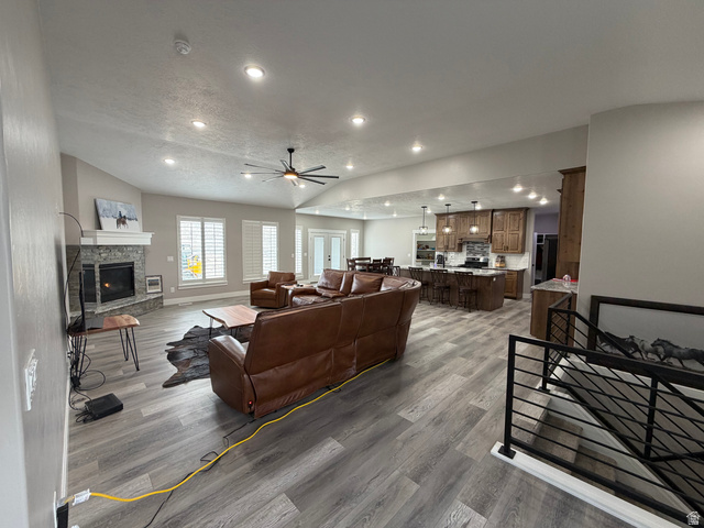 2350 North 1075 West Helper, UT 84526 - Photo 6 of 49 Living area featuring ceiling fan, a fireplace, wood finished floors, vaulted ceiling, and recessed lighting