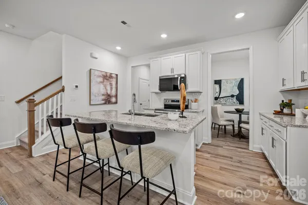a kitchen with stainless steel appliances kitchen island granite countertop a sink and cabinets