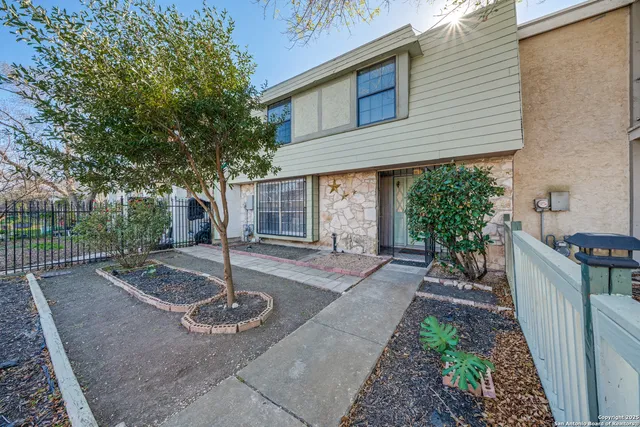 a view of a patio with table and chairs with wooden fence and plants