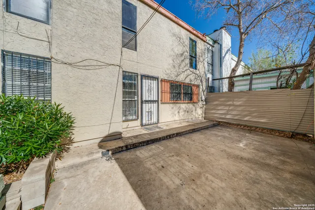 a view of a house with a wooden fence