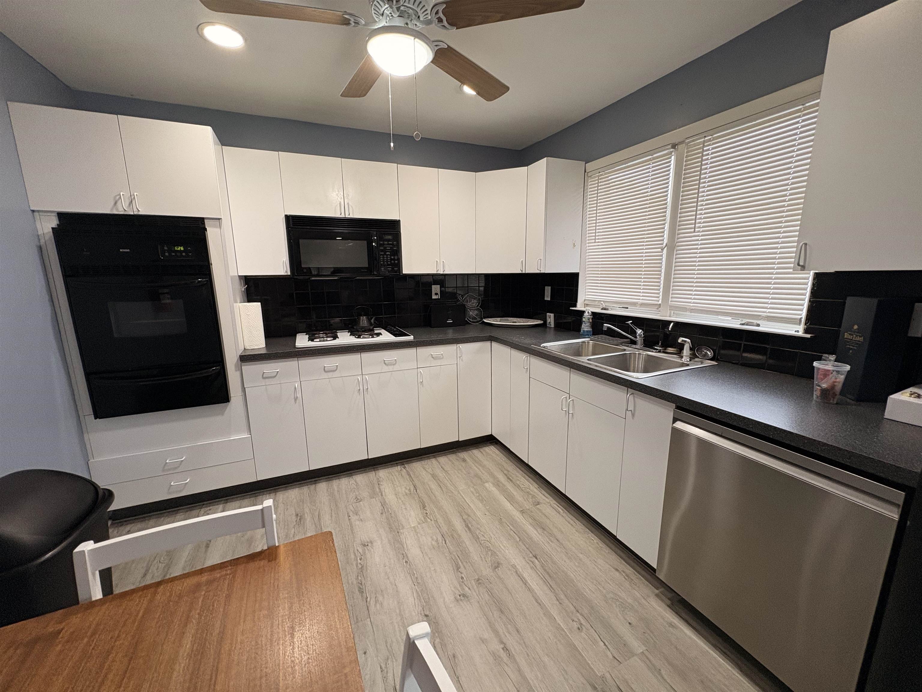 32 Franklin Street, Unit 2 Hackensack, NJ 07601 - Photo 5 of 13 a kitchen with stainless steel appliances a sink dishwasher a stove top oven a refrigerator with wooden floor and cabinets