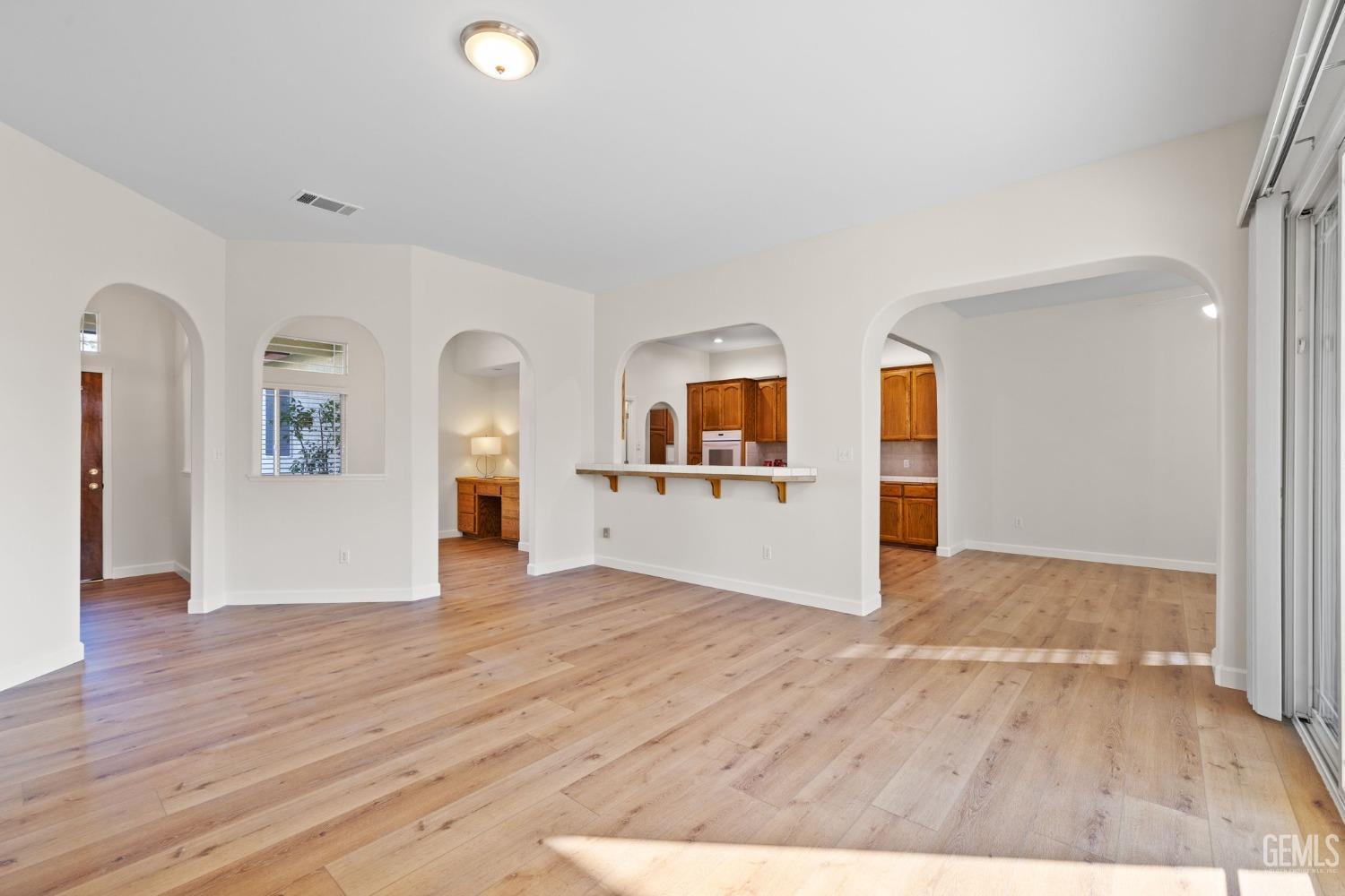 Undisclosed Address Bakersfield, CA 93313 - Photo 13 of 50 a view of a big room with wooden floor and windows