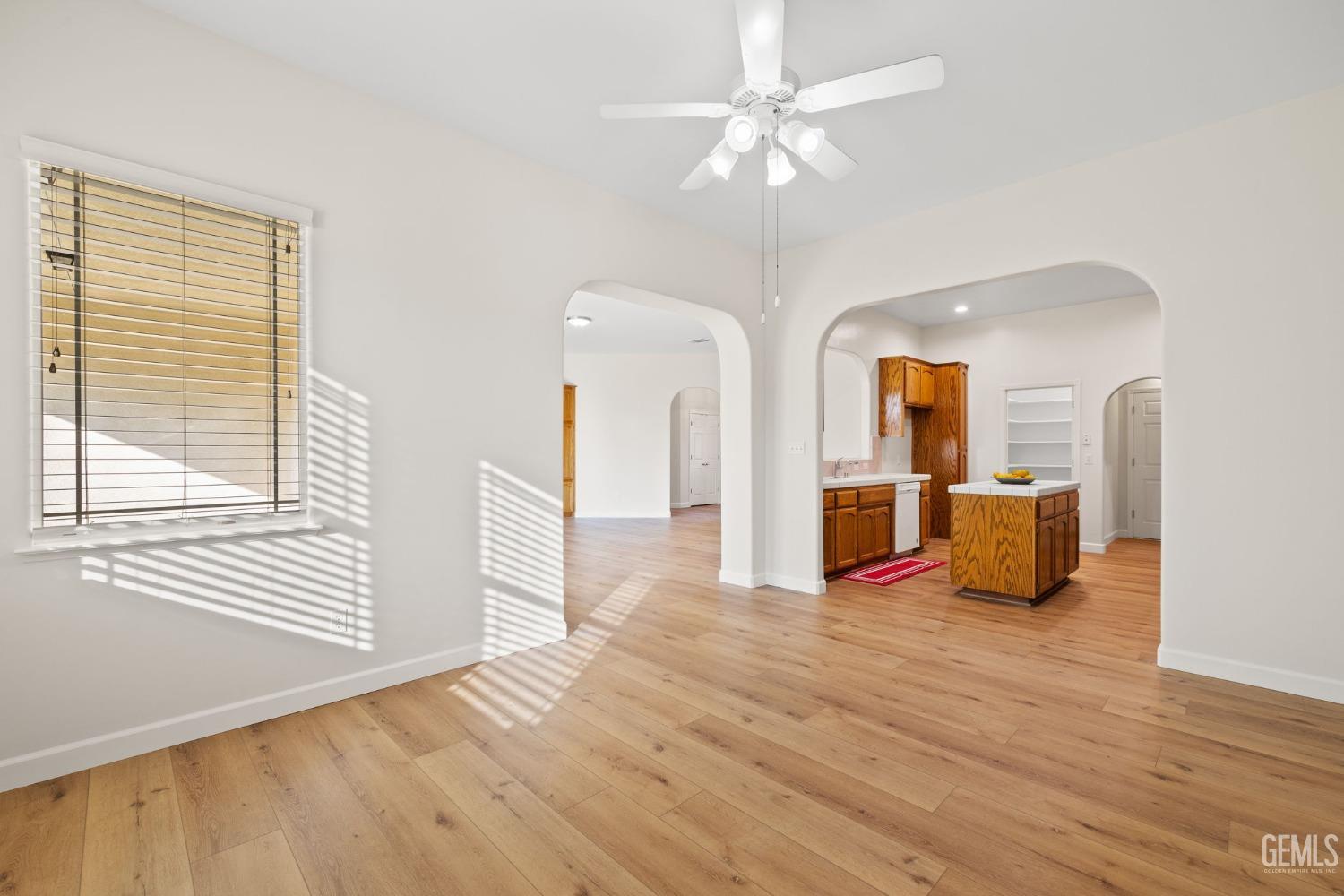 Undisclosed Address Bakersfield, CA 93313 - Photo 17 of 50 a view of a livingroom with wooden floor and a ceiling fan