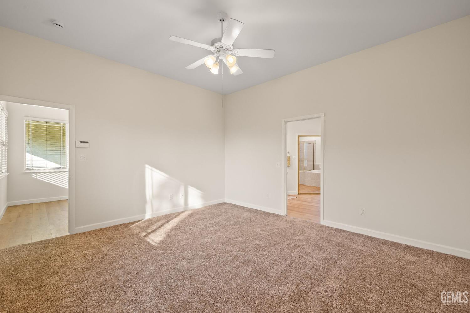 Undisclosed Address Bakersfield, CA 93313 - Photo 27 of 50 a view of an empty room with a chandelier fan
