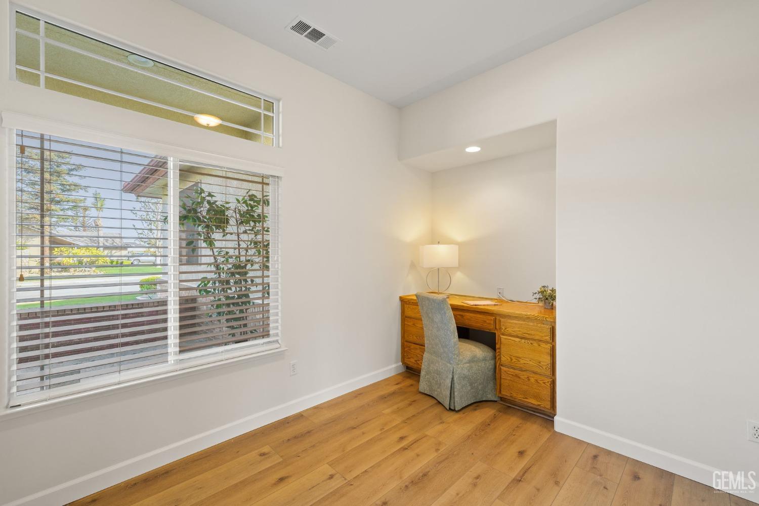 Undisclosed Address Bakersfield, CA 93313 - Photo 33 of 50 a view of an empty room with wooden floor and a window