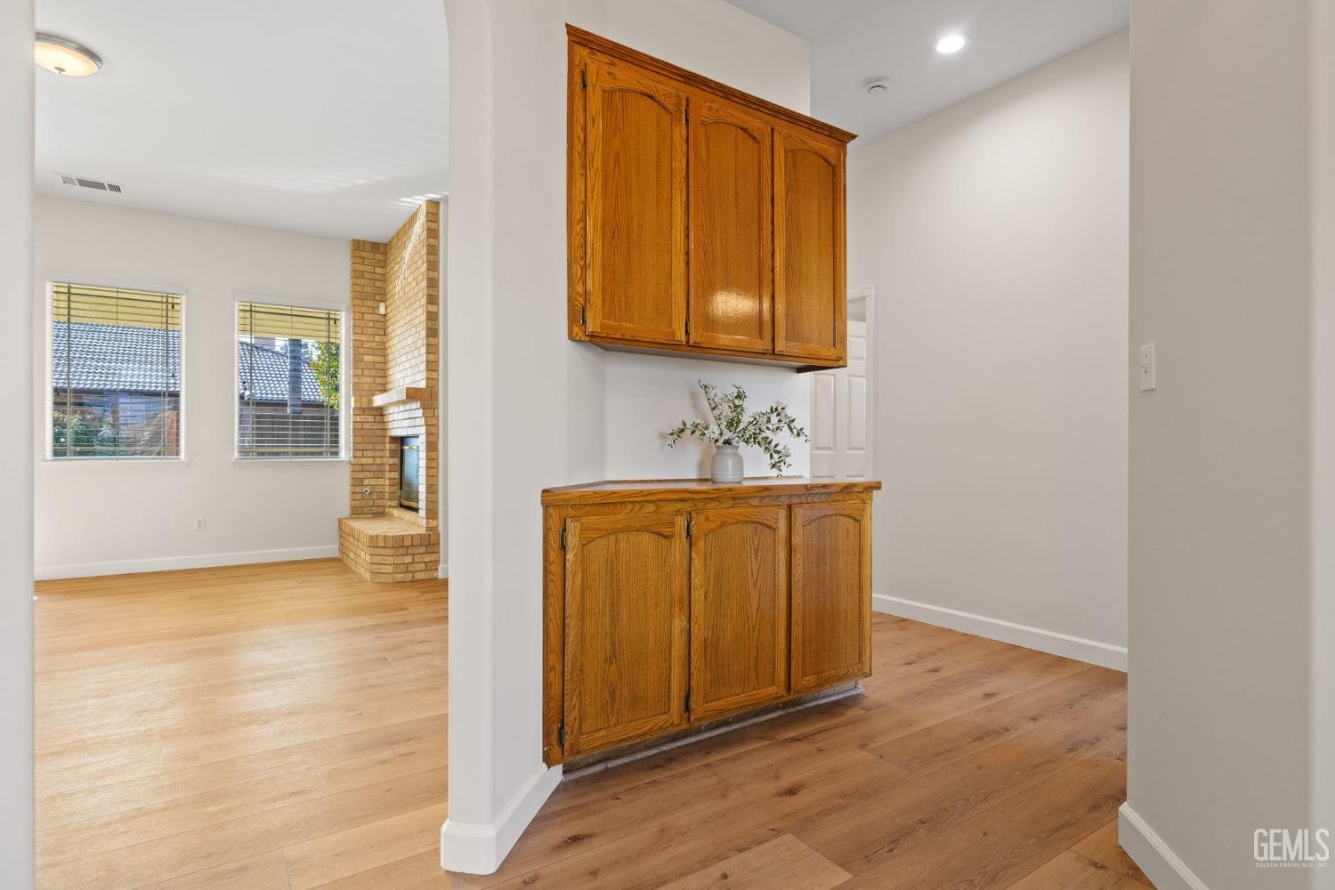 Undisclosed Address Bakersfield, CA 93313 - Photo 35 of 50 a view of a hallway with wooden floor and a cabinet