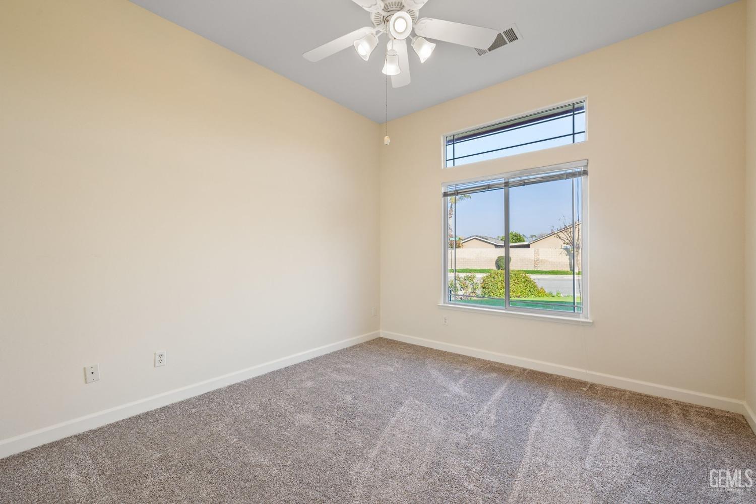 Undisclosed Address Bakersfield, CA 93313 - Photo 36 of 50 an empty room with windows and fan