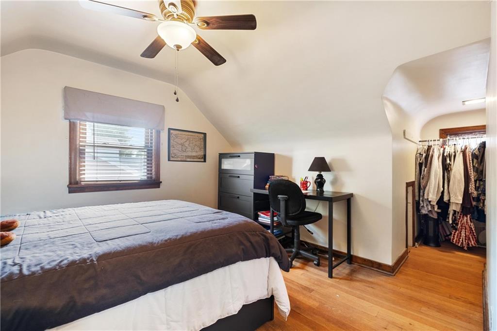 696 Filmore Road Pittsburgh, PA 15221 - Photo 23 of 37 a bedroom with a bed and a chandelier