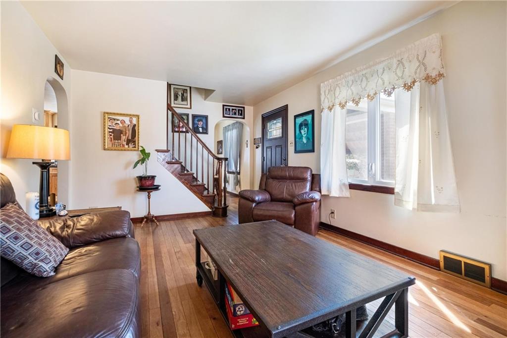 696 Filmore Road Pittsburgh, PA 15221 - Photo 10 of 37 a living room with furniture and a table