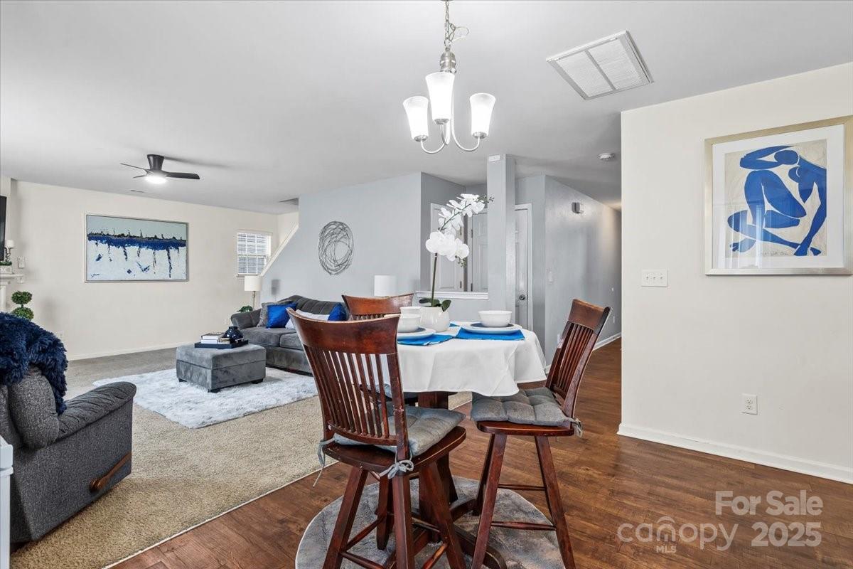 1848 Greenbrook Trail Dallas, NC 28034 - Photo 11 of 33 a view of a dining room with furniture a chandelier and wooden floor