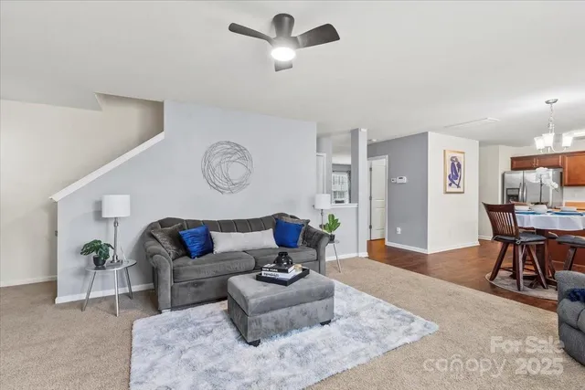 a living room with furniture and a clock